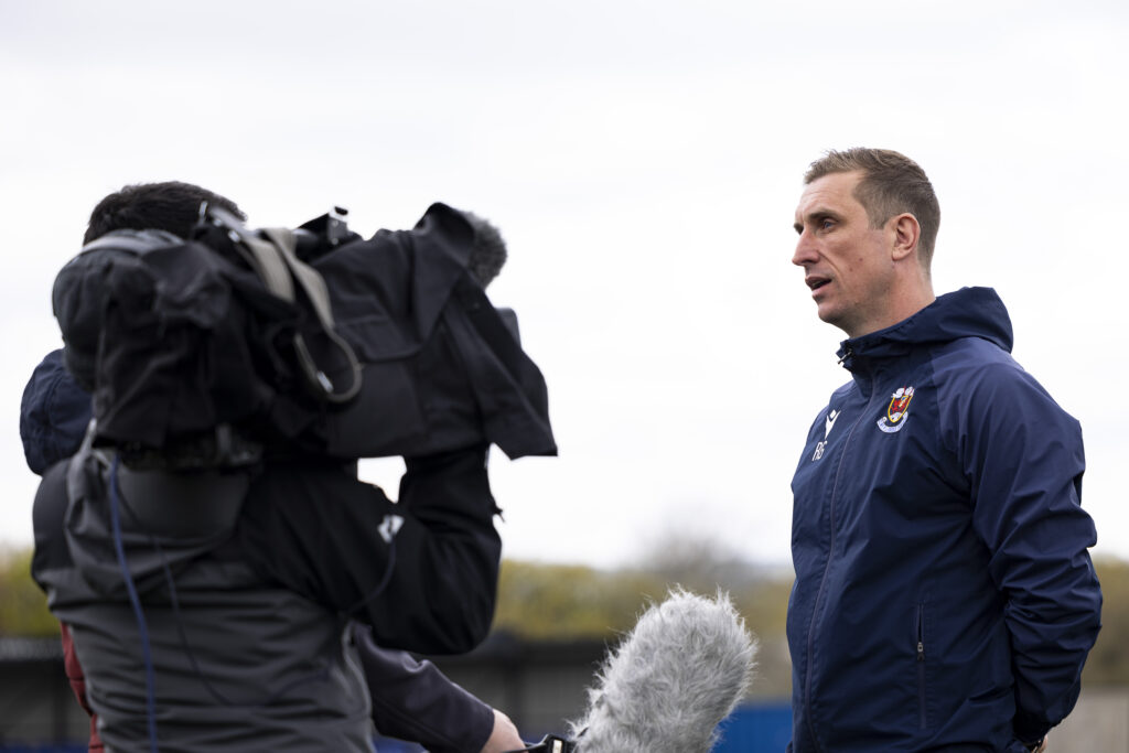 Penybotn manager Rhys Griffiths speaks to Sgorio ahead of dog the match. Penybont v Haverfordwest County in the JD Cymru Premier at the SDM Glass Stadium on the 21st April 2024