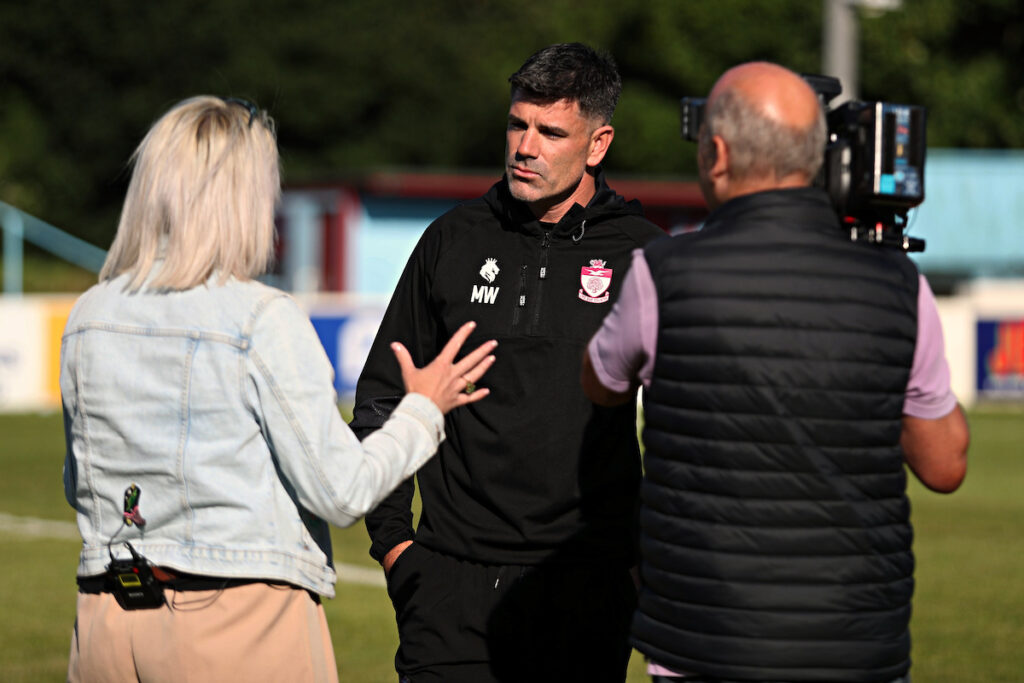 Nicky John from S4C Sgorio interviews Colwyn Bay boss Mike Wilde with a cameraman alongside her