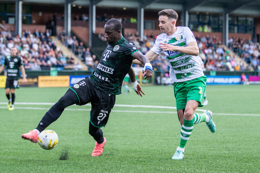 Ferencvaros' Ibrahim Cisse and The New Saints' Danny Davies during the UEFA Champions’ League Second Qualifying Round Second Leg fixture between The New Saints and Ferencvaros at Park Hall Stadium, Oswestry, England