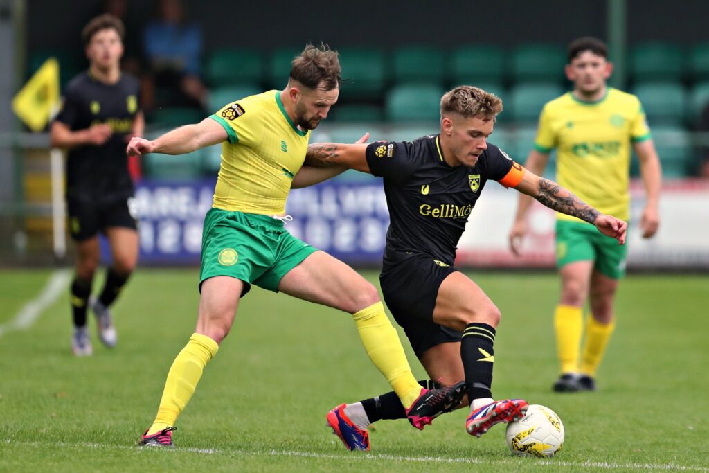 Caernarfon's Gruff John pressures Haverfordwest's Corey Shepherd during Caernarfon Town vs Haverfordwest County in Round 2 of the JD Cymru Premier at The Oval, Caernarfon