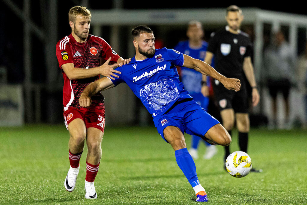 Ben Guest (L) in action for Newtown against Penybont in the JD Cymru Leagues Premier.
