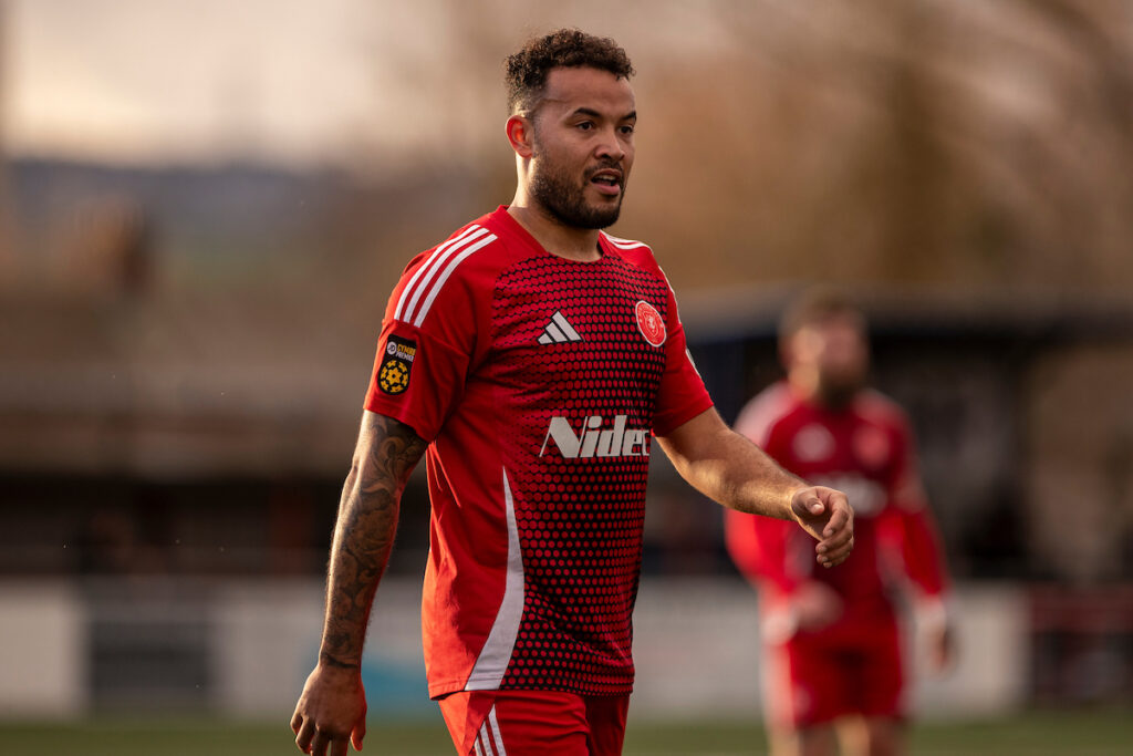 Caernarfon Town's Dominic Smith in action for Newtown in the JD Cymru premier.