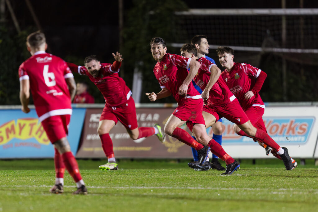 Llanelli's Sean Cronin scores and celebrates during the 2024/25 JD Cymru South fixture between Llanelli Town AFC and Trethomas Bluebirds AFC at Stebonheath Park, Llanelli, Wales
