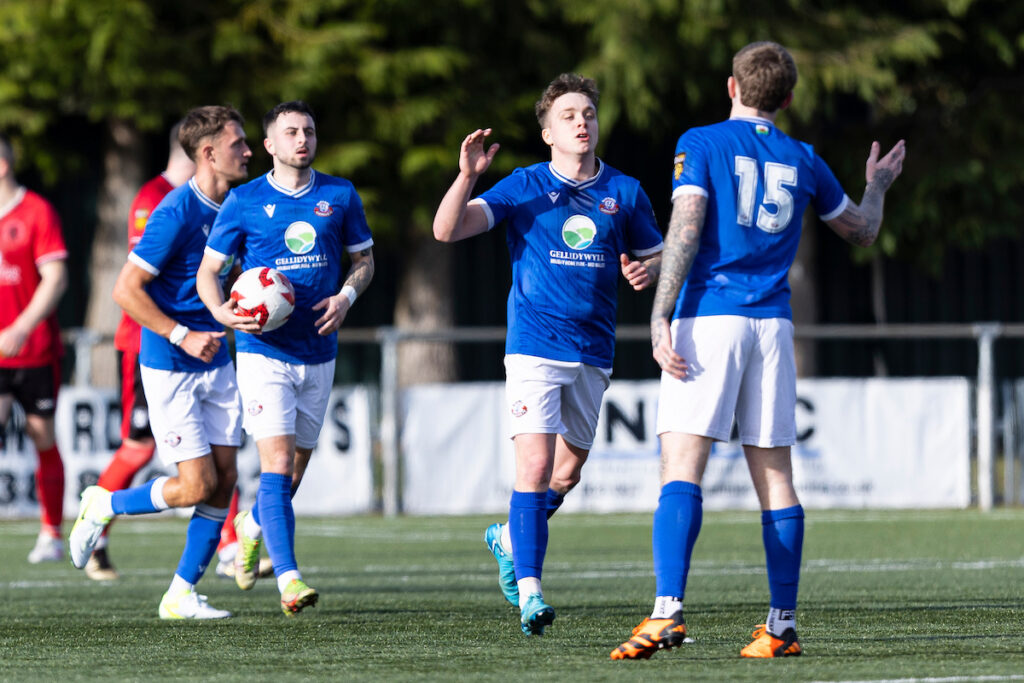 Tommy Rowlands of Caersws celebrates scoring his sides first goal during the 2024/25 JD Cymru North fixture between Caersws and Penrhyncoch at Latham Park, Newtown, Wales