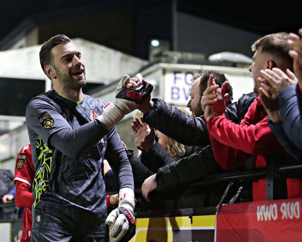 Will Fuller of Briton Ferry Llansawel celebrates with fans after Aberystwyth Town vs Briton Ferry Llansawel in Round 29 of the JD Cymru Premier Play-Off Conference at Park Avenue, Aberysywth