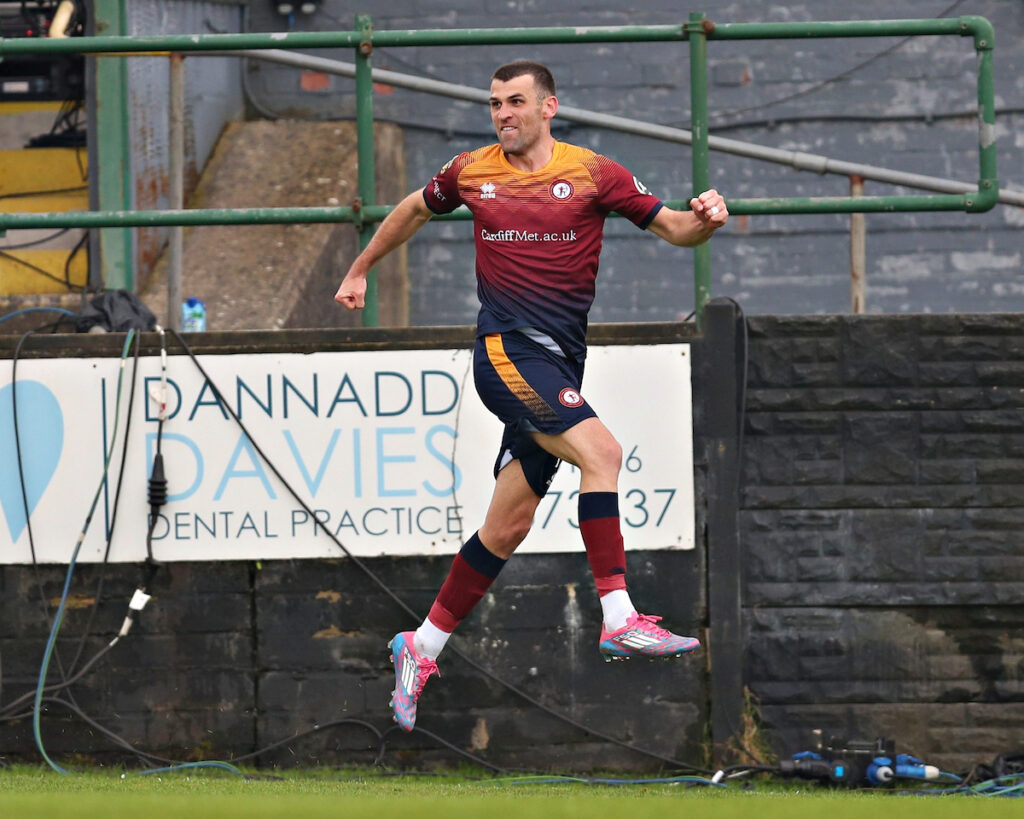 Cardiff Met's Adam Roscrow celebrates his goal during Caernarfon Town vs Cardiff Metropolitan University FC in Round 32 of the JD Cymru Premier at The Oval, Caernarfon
