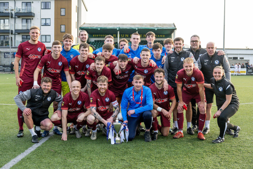 Jordan Evans of Airbus UK Broughton celebrates winning the 2024/25 Welsh Blood Service League Cup Final fixture between Trefelin BGC v Airbus UK Broughton FC at Park Avenue, Aberystwyth, Wales