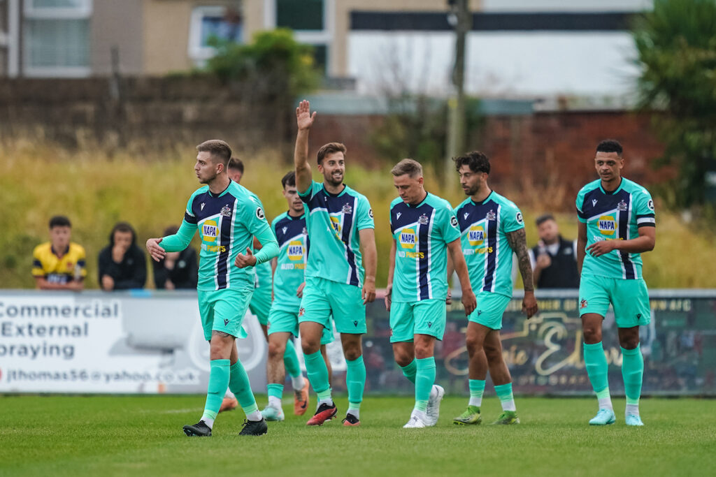 Barry Town United players celebrating Ben Williams-Margetson of Barry Town United’s goal during the JD Cymru Premier 2025/26 fixture Llanelli Town vs Barry Town United at Stebonheath Park, Llanelli, Wales