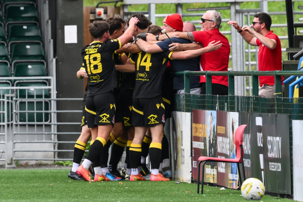 Ruben Davies of Briton Ferry Llansawel celebrates his goal to make it 0-3  with his fans during the JD Cymru Premier between The New Saints and Briton Ferry Llansawel at the Park Hall Stadium in Oswestry on the 10th August 2025
