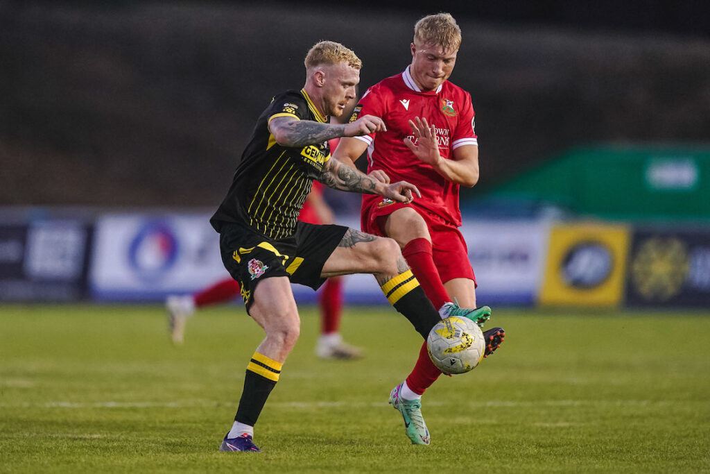 Tom Walters of Briton Ferry Llansawel and Harrison Bright of Llanelli Town during the JD Cymru Premier 2025/26 fixture Llanelli Town vs Briton Ferry Llansawel at Stebonheath Park, Llanelli, Wales