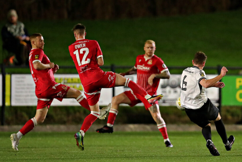 Dom McGiveron of Bala Town shoots during Bala Town vs Briton Ferry Llansawel in Round 8 of the JD Cymru Premier at Maes Tegid, Bala