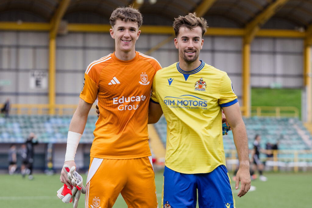 BARRY, WALES - 27 SEPTEMBER 2025: Brothers Connah's Quay Nomads goalkeeper Kit Margetson and Barry Town's Ben Williams-Margetson after the 0-0 game in  the 2025/26 JD Cymru Premier fixture between Barry Town United FC & Connahs Quay Nomads FC at Jenner Park Stadium, Barry, Wales