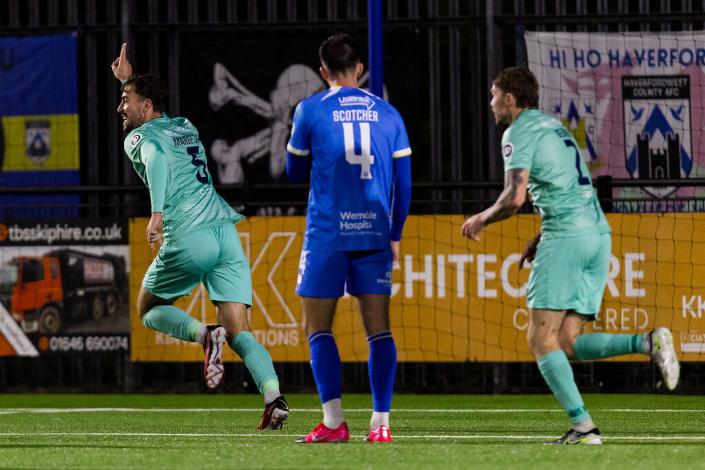 Barry Town's Ben Williams-Margetson scores and celebrates 2-3 during the 2025/26 JD Cymru Premier league fixture between Haverfordwest County AFC & Barry Town United FC at The Bridge Meadow Stadium, Wales