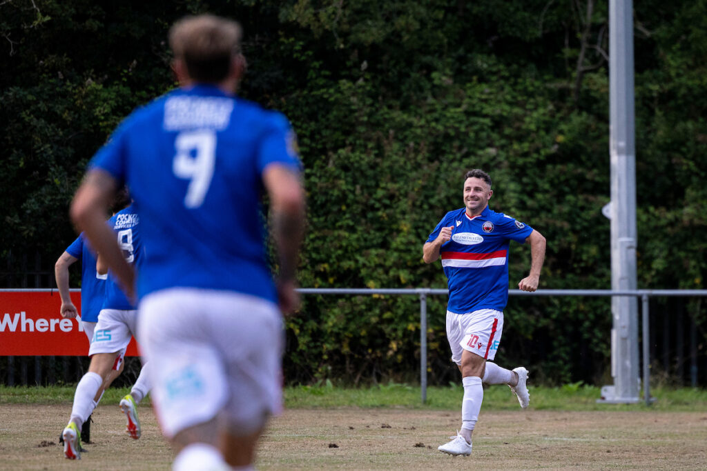 Luke Bowen celebrates after scoring for Trefelin BGC against Caerau Ely in the Nathaniel MG Cup