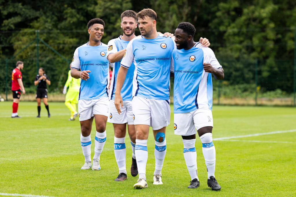 Kayne Mclaggon celebrates with Luke Cooper and his other Newport City teammates