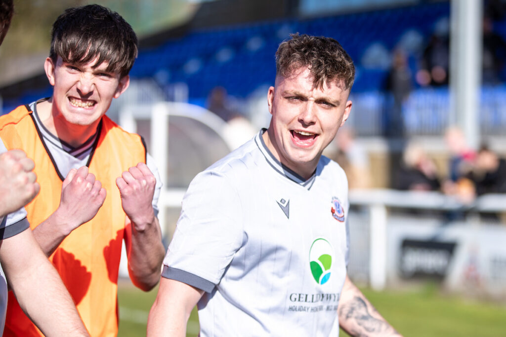 Match winner Caersws' Tommy Rowlands celebrates at full time following the JD Cymru North fixture between Bangor 1876 and Caersws at Bangor City Stadium, Bangor. 5th of April, Connah’s Quay, Wales