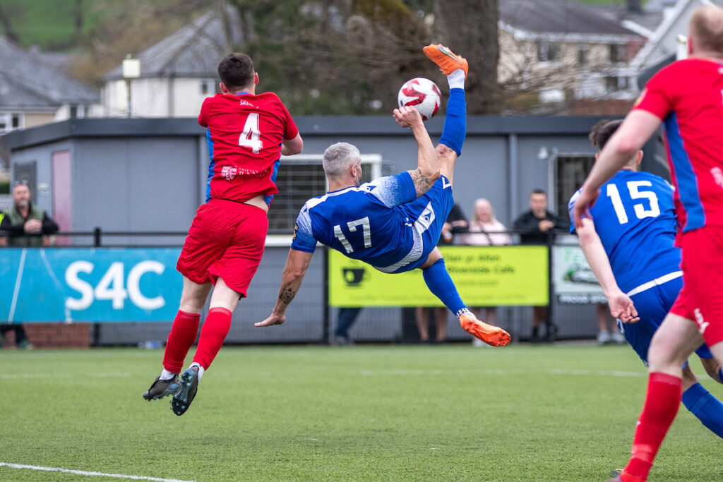 Ruthin Town's Jamie Reed scores a late bicycle kick during the JD Cymru North fixture between Ruthin Town and Bangor 1876 at Maes Tegid, Bala. 12th of April, Bala, Wales