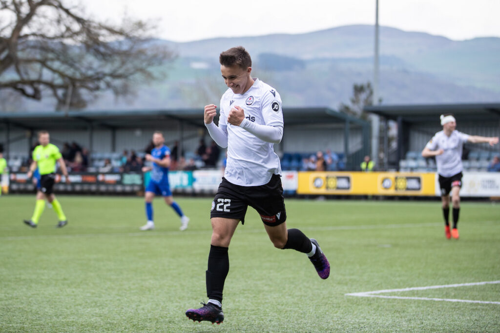 Bala Town’s Callum Edwards doubles the home side’s advantage during the JD Cymru Premier fixture between Bala Town and Penybont at Maes Tegid, Bala. 19th of April, Bala, Wales