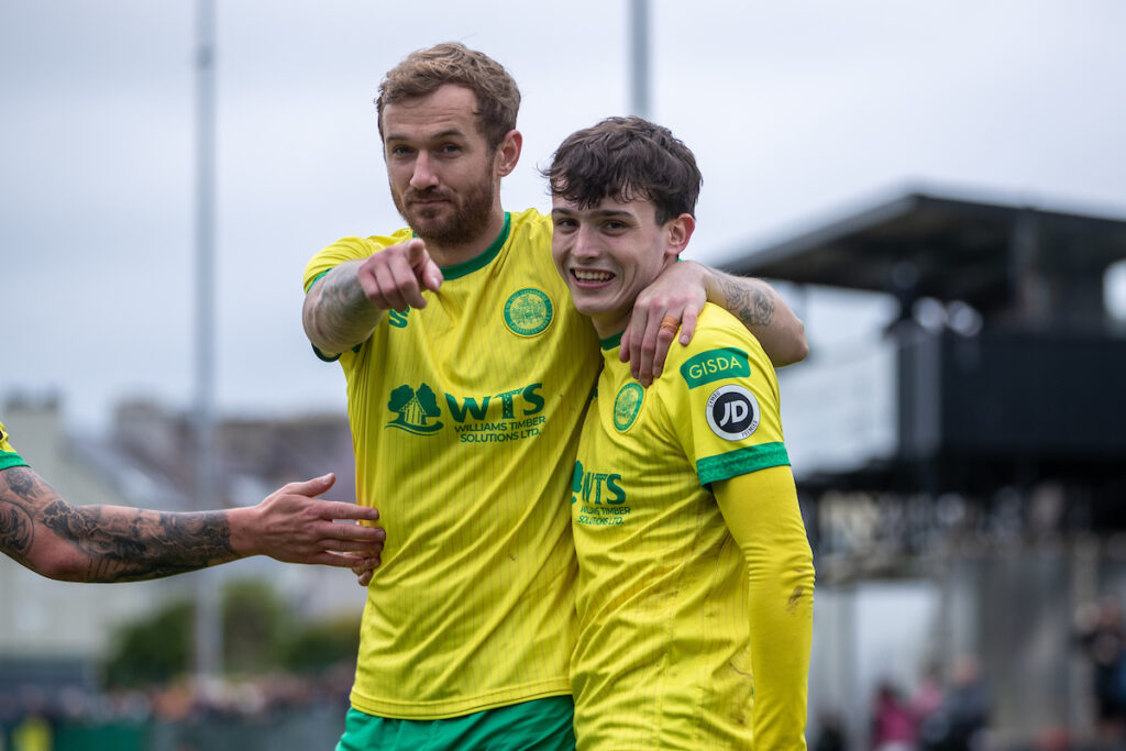 Caernarfon Town's Louis Lloyd completes his hat-trick from the penalty spot during the JD Cymru Premier Playoff fixture between Caernarfon Town and Barry Town United at the Carling Oval, Caernarfon, Wales
