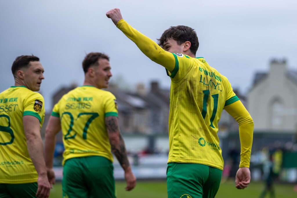 Caernarfon Town's Louis Lloyd completes his hat-trick from the penalty spot during the JD Cymru Premier Playoff fixture between Caernarfon Town and Barry Town United at the Carling Oval, Caernarfon, Wales