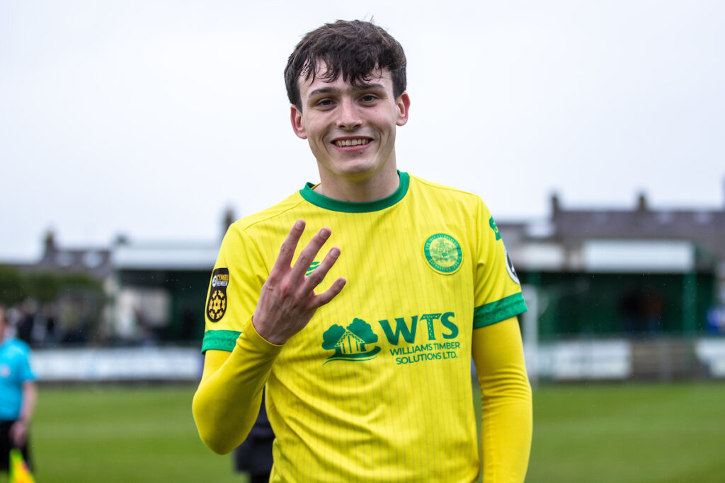 Caernarfon Town's Louis Lloyd celebrates his four goals at full time following the JD Cymru Premier Playoff fixture between Caernarfon Town and Barry Town United at the Carling Oval, Caernarfon, Wales