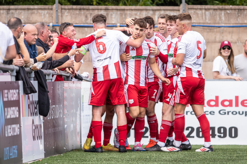 Fabrizio Murtas celebrates scoring for Holywell Town against Flint Town United in the Nathaniel MG Cup.