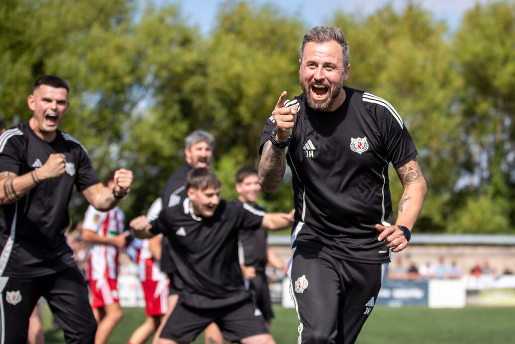 Holywell Town Manager Johnny Haseldin celebrates at full time following the Nathaniel MG Cup Second Round fixture between Flint Town United and Holywell Town at the Essity Stadium, Flint. 2nd of August, Flint, Wales