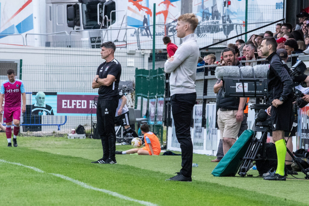 Former colleagues Mike Wilde and John Disney oversee the game during the JD Cymru Premier fixture between Colwyn Bay and Connah’s Quay Nomads at Blue Turtle Arena, Colwyn Bay, 10th of August, Colwyn Bay, Wales