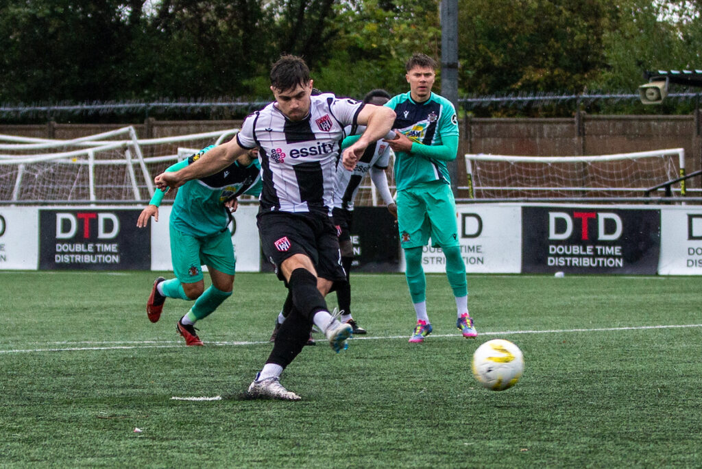 Flint Town United's Joshua Jones misses a late penalty during the JD Cymru Premier fixture between Flint Town United and Barry Town United at the Essity Stadium, Flint. 20th of September, Flint, Wales