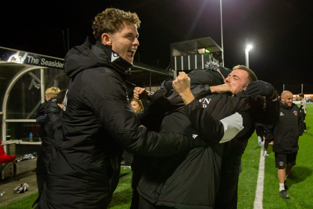 LLANDUDNO, WALES - 21ST NOVEMBER 2025: Llandudno players and staff celebrate their win at full time following the JD Welsh Cup fixture between Llandudno and Connah’s Quay Nomads at the Go Goodwins Stadium, Llandudno. 18th of November, Llandudno, Wales