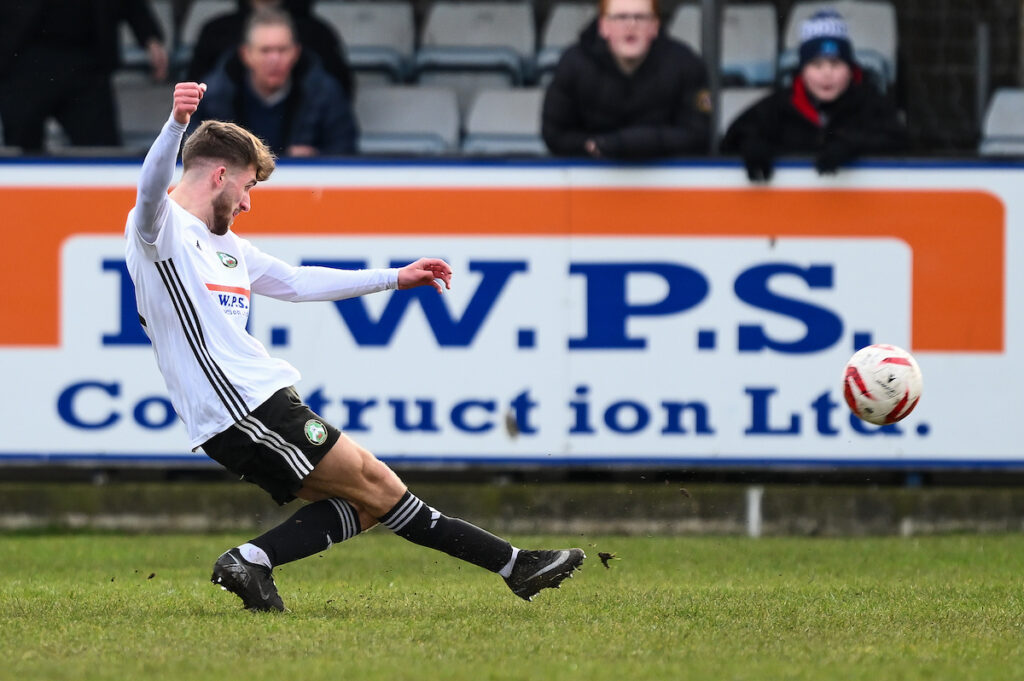 Jack Parry of Rhyl 1879 shoots on goal during the JD Welsh Cup between Rhyl 1879 and Barry Town United at the Hops and Barley Community Stadium in Rhyl