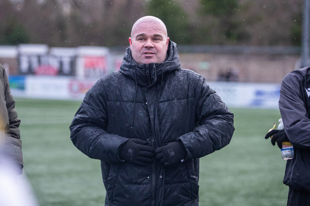Flint Town United's Manager, Lee Fowler speaks to his players following the JD Welsh Cup fixture between Flint Town United and Trearddur Bay at the Essity Stadium, Flint. 31st of January, Flint, Wales