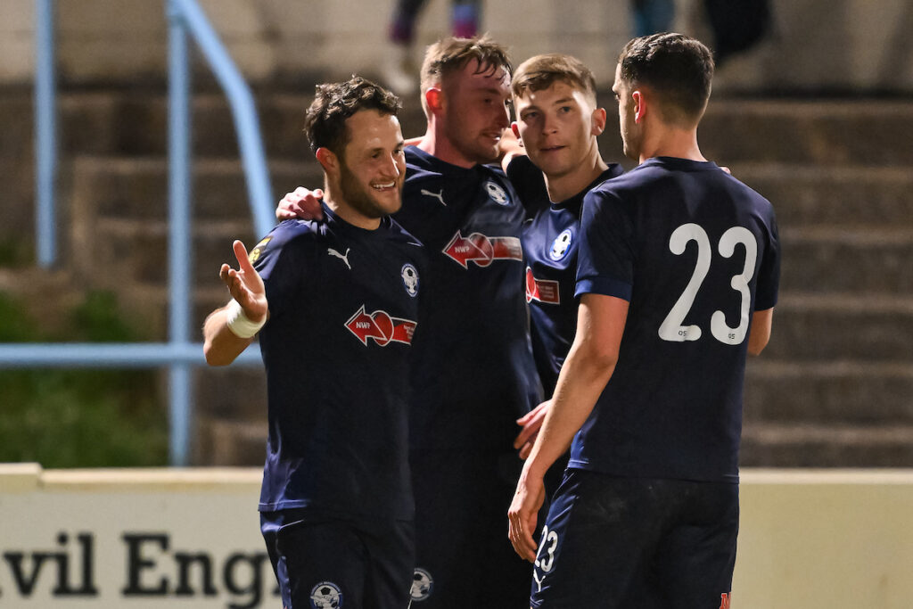 James Davies of Airbus UK Broughton celebrates his goal to make it 1-3 during the Welsh Blood Service League Cup 2024/25 fixture between Colwyn Bay FC & Airbus UK Broughton at Four Crosses Construction Arena, Colwyn Bay, Wales