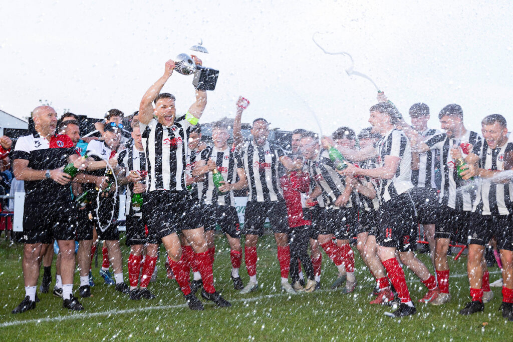 Cardiff Dracs lift the Ardal South West title, celebrating promotion to the JD Cymru South. 
