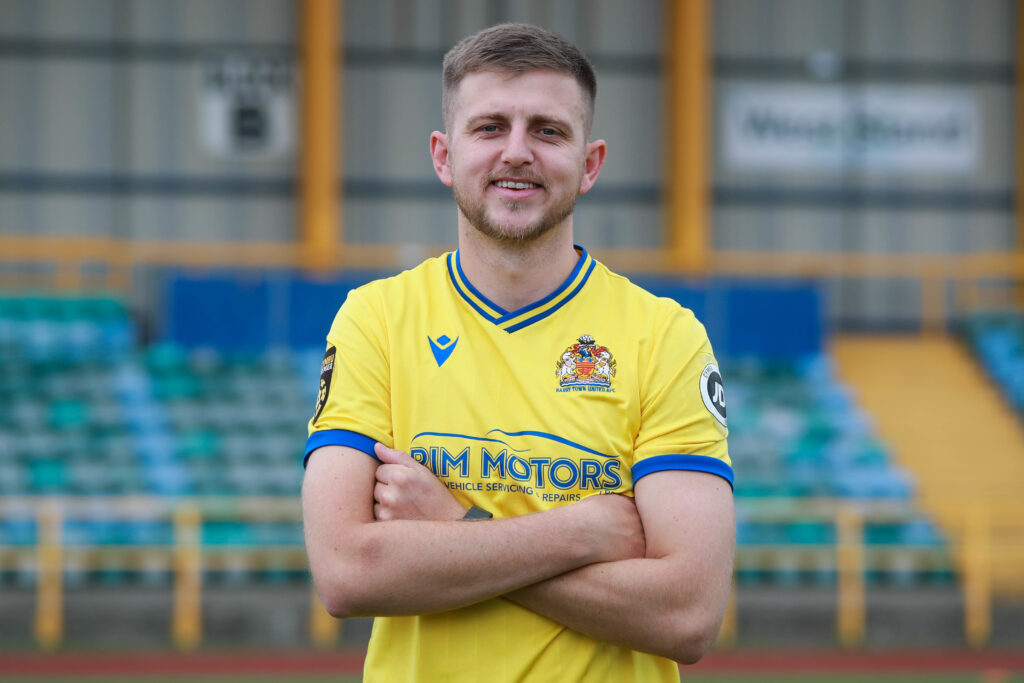 Keston Davies poses in a Barry Town United shirt 