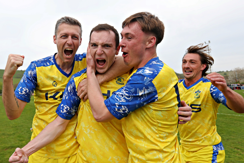 Colwyn Bay players celebrate after winning the JD Cymru North