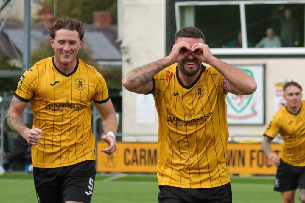 Liam Thomas celebrates scoring for Carmarthen Town against Newport City in the JD Cymru South. 