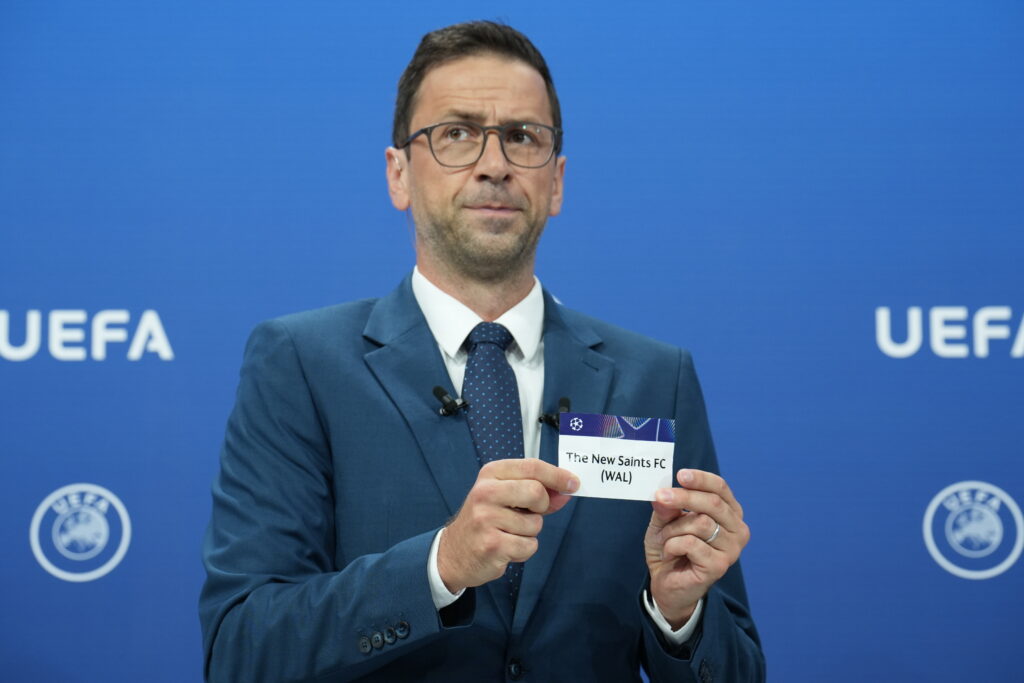 A UEFA official holds up a card with The New Saints FC (WAL) on during a UEFA Champions League draw